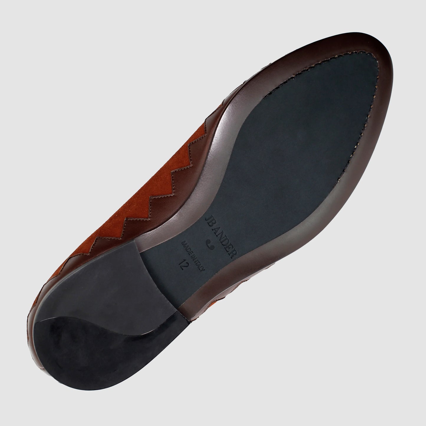 Leather sole of the JB Ander Great White smoking slipper loafers in SoHo Sunset burnt umber color suede, showing polished brown leather edge, 'Made in Italy' detail, and slim rubber heel for comfort and grip.
