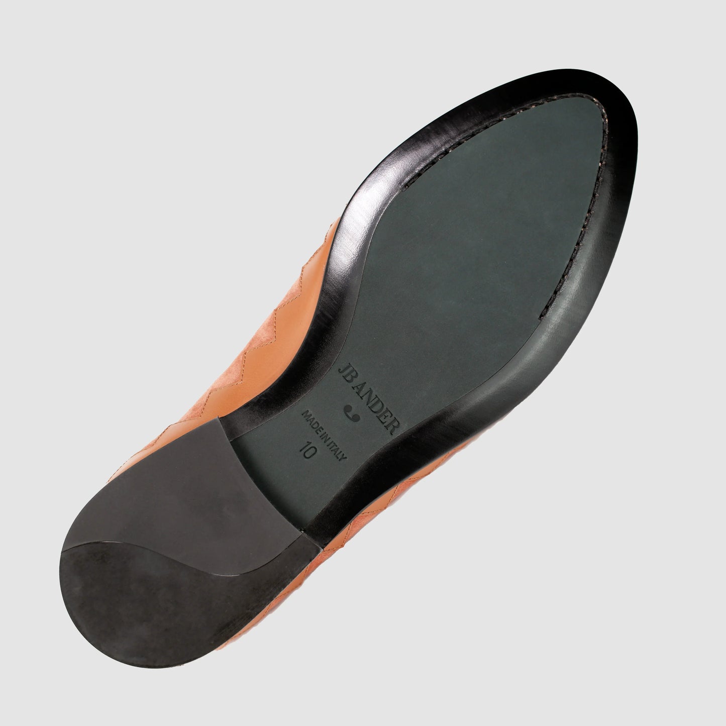 Leather sole of the JB Ander Great White smoking slipper loafers in Terracotta suede, showing polished black leather edge, 'Made in Italy' detail, and slim rubber heel for comfort and grip.