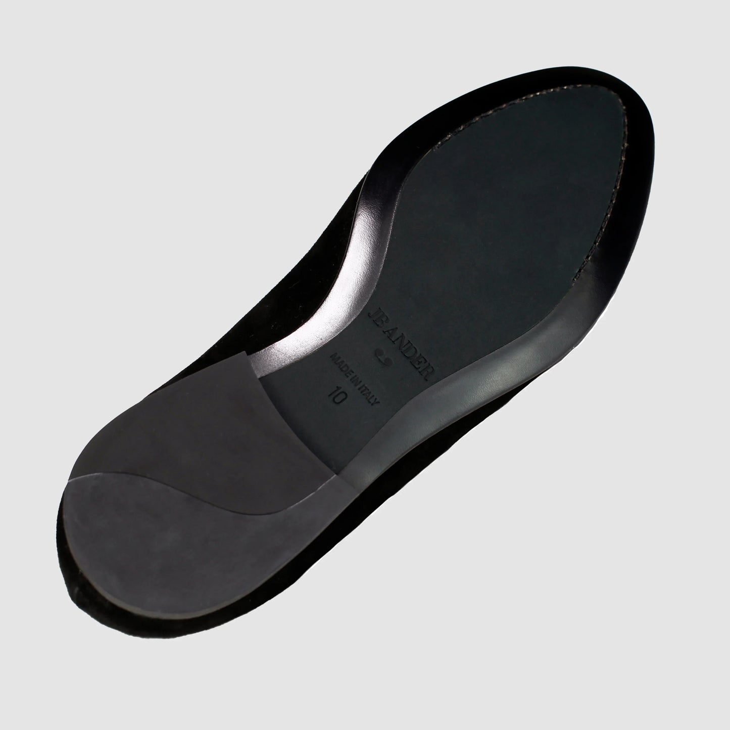 Leather sole of the JB Ander Valedictorian tassel loafers in Nero black suede, showing polished black leather edge, 'Made in Italy' detail, and slim rubber heel for comfort and grip.
