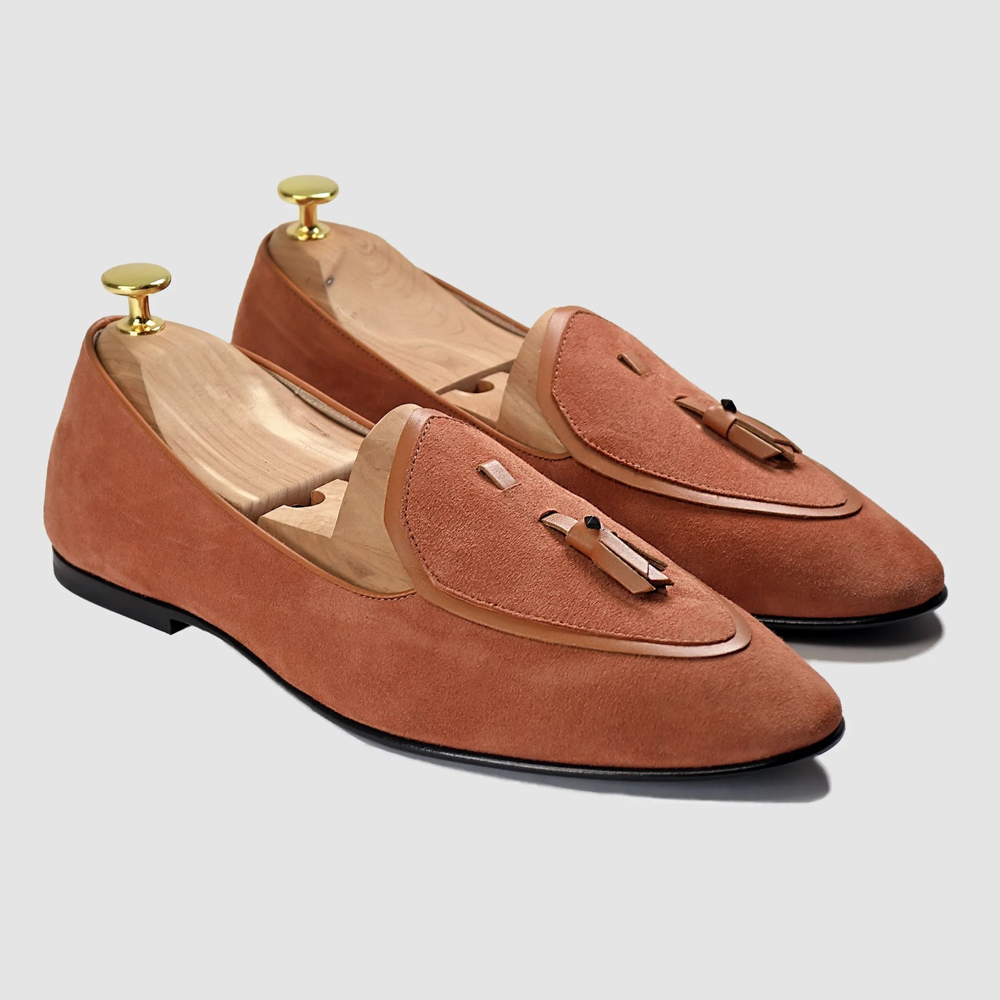 Terracotta suede Valedictorian tassel loafers by JB Ander, featuring supple leather trim, minimalist slip-on design, and polished Italian craftsmanship.