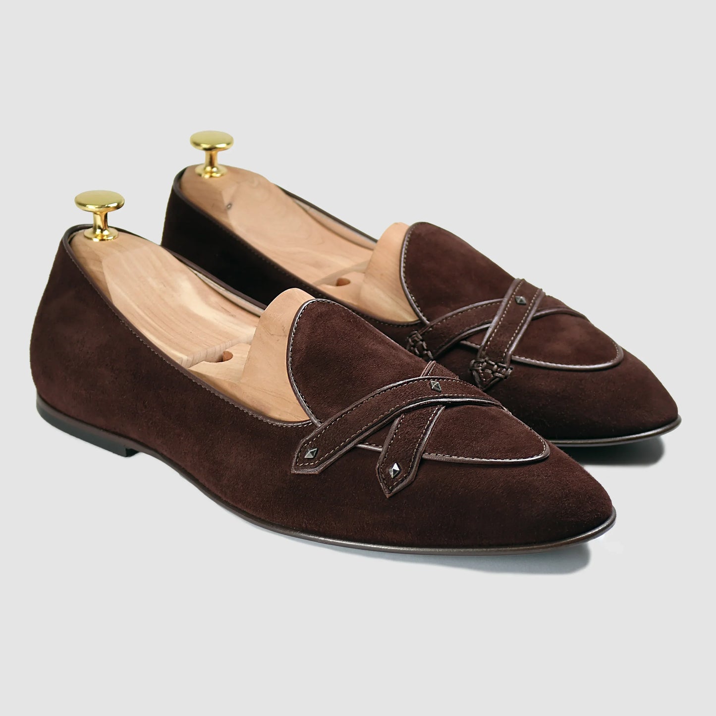 Brown Italian suede Lincoln saddle loafers by JB Ander, front three-quarter angle showing leather double cross-strap detail, antiqued gold metal accents, and leather outsole edge.