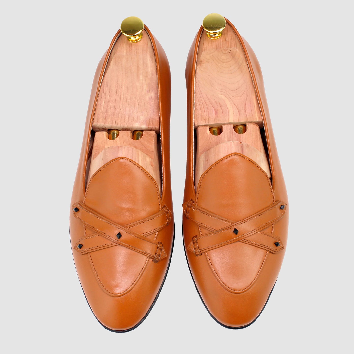 Overhead view of JB Ander men's Lincoln saddle loafers in terracotta leather with dual leather strap, metal accessories, and handmade Italian craftsmanship.