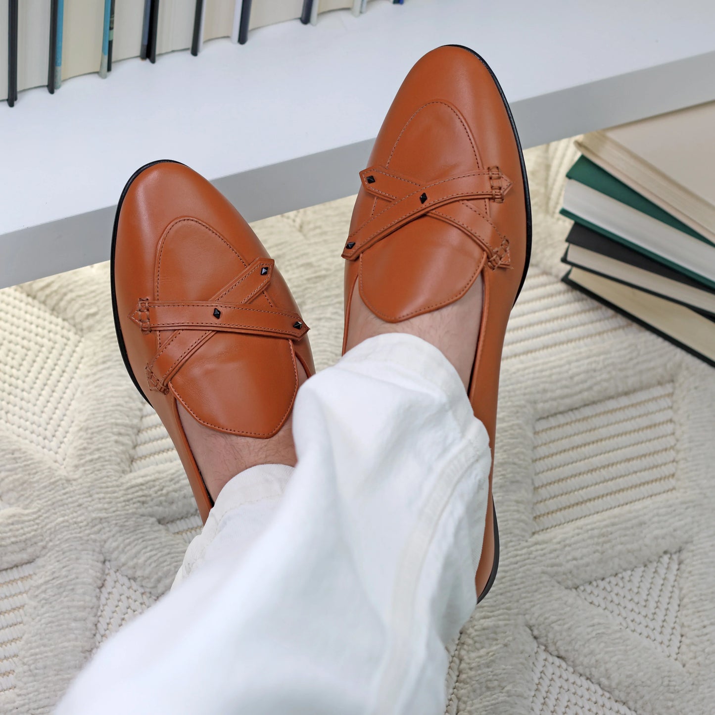 Model wearing JB Ander Lincoln saddle loafers in terracotta leather – handcrafted Italian loafers with dual leather straps, minimalist slip-on design, and sleek sole.