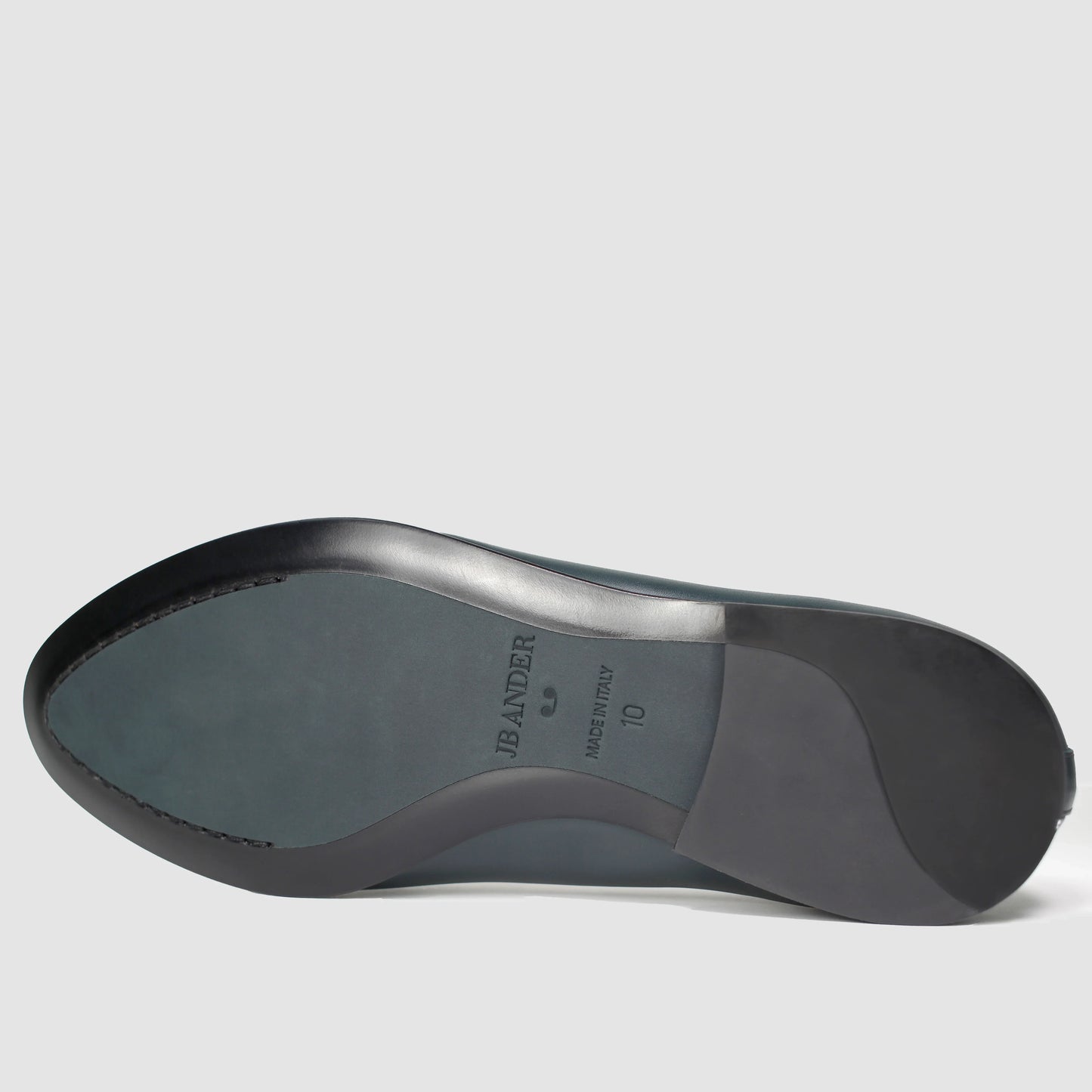 Leather sole of the JB Ander Scottie kilt loafer in Verde green leather, showing polished black leather edge, 'Made in Italy' detail, and slim rubber heel for comfort and grip.