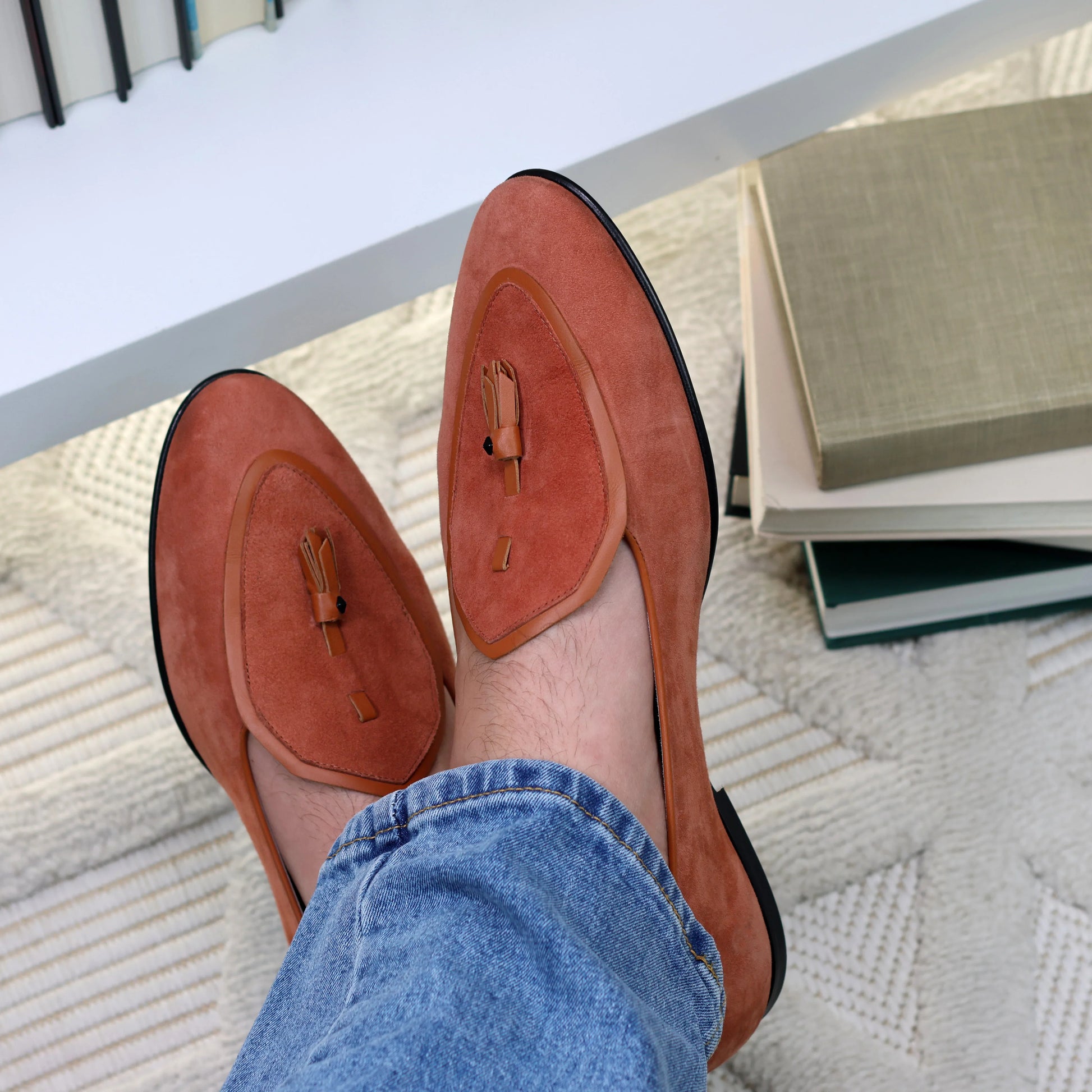 Model wearing JB Ander men's Valedictorian tassel loafers in Terracotta suede with leather trim, and handmade Italian craftsmanship.