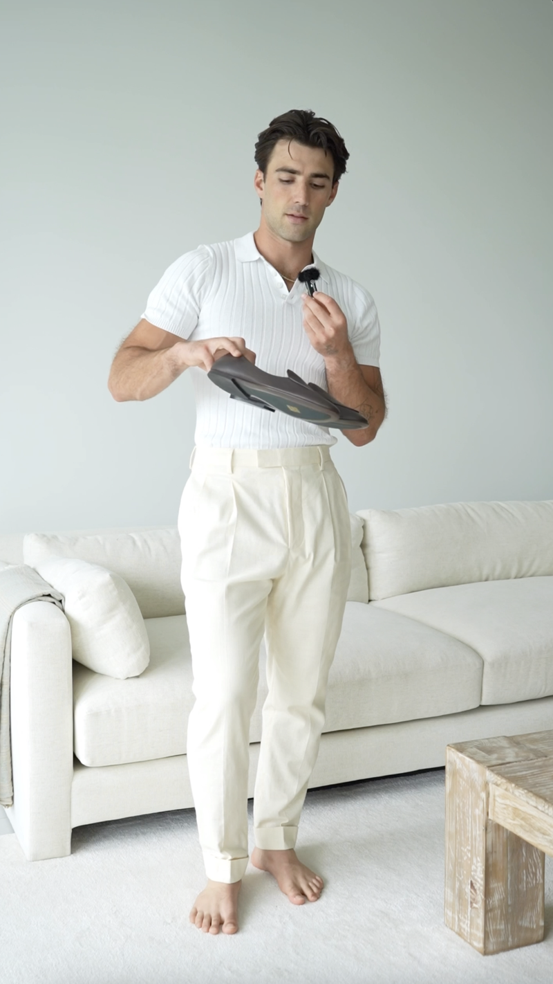 Model holding JB Ander Venetian loafers, the Vivaldi, in espresso brown pebbled leather
