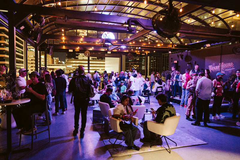 Texas House and JB Ander event-gathered in a large indoor space with high ceilings and modern decor.