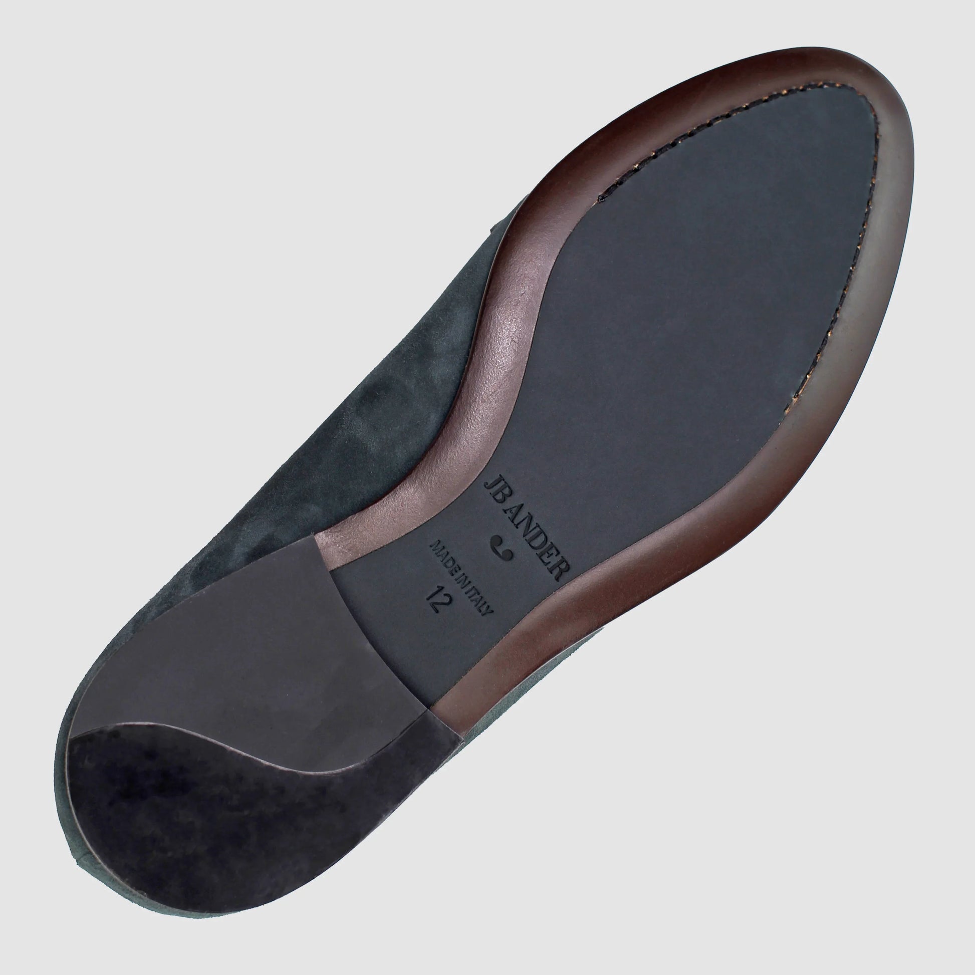 Leather sole of the JB Ander Lincoln saddle loafer in Empire Emerald suede, showing polished brown leather edge, 'Made in Italy' detail, and slim rubber heel for comfort and grip.