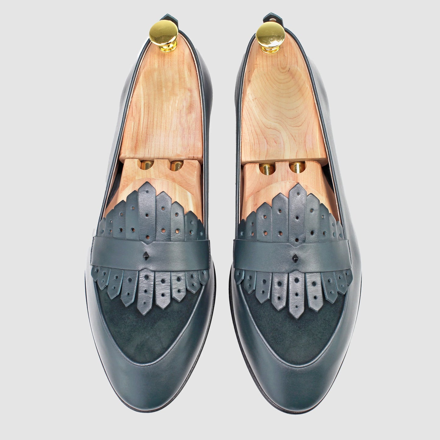 Overhead view of JB Ander men's Scottie kilt loafers in Verde green leather with dual leather fringe, suede trim, and handmade Italian craftsmanship.